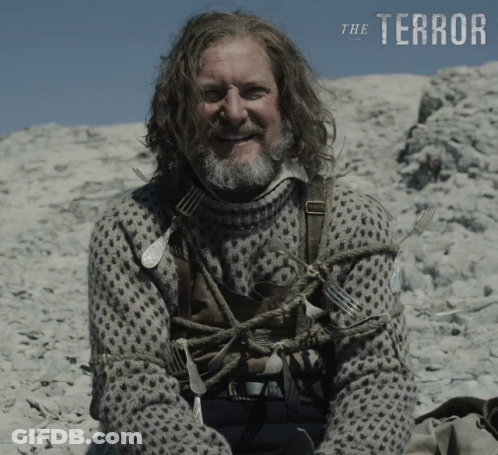Man With Long Hair And Beard On Rocky Hill Saying Terror GIF