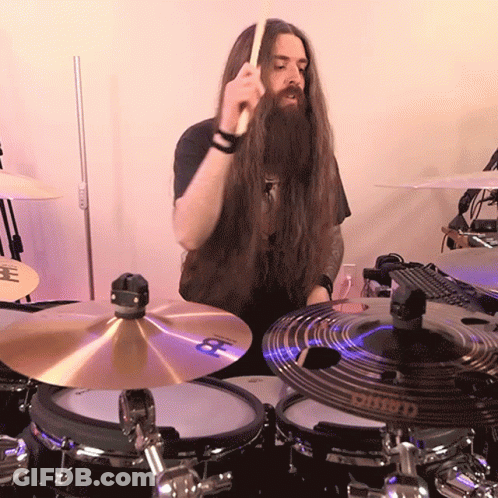 Man With Long Hair And Beard Playing Drum Set GIF