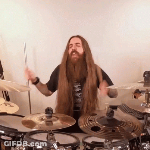 Man With Long Hair And Beard Playing Drum Set GIF