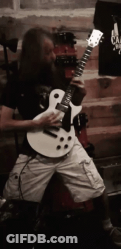 Man With Long Hair And Beard Playing White Guitar GIF