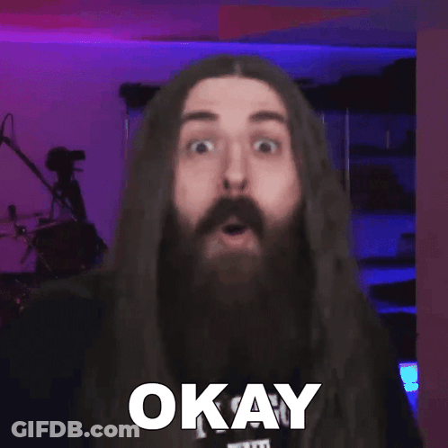 Man With Long Hair And Beard Says Okay At Microphone GIF