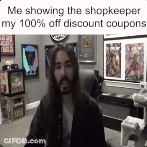 Man With Long Hair And Beard Sitting In Front Of Fuel Sign GIF
