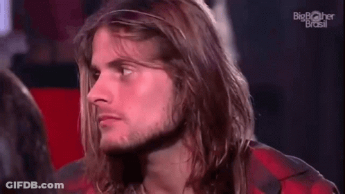 Man With Long Hair And Beard Sitting In Red Chair GIF