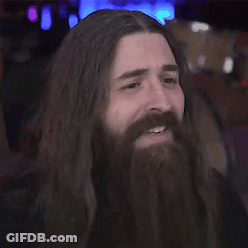 Man With Long Hair And Beard Smiles GIF