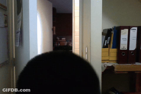 Man With Long Hair And Beard Standing In Dark Room GIF