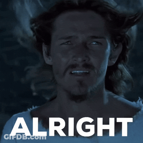 Man With Long Hair And Beard Standing In Front Of Alright Sign GIF