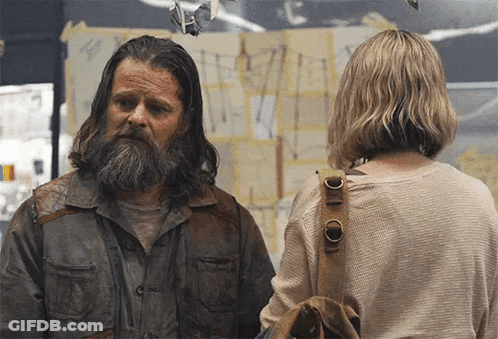 Man With Long Hair And Beard Stands Next To Woman GIF