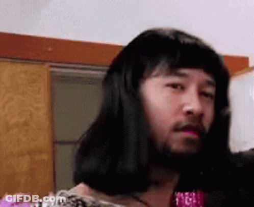 Man With Long Hair And Beard Wearing Wig Looking At Camera GIF