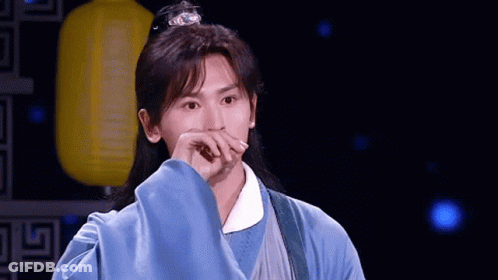 Man With Long Hair And Blue Robe Covering Mouth GIF
