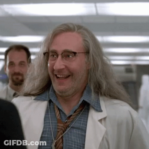 Man With Long Hair And Glasses In Lab Coat And Tie GIF