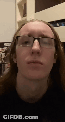 Man With Long Hair And Glasses Making Funny Face GIF