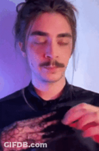 Man With Long Hair And Mustache In Black Lace Top GIF