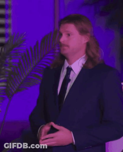 Man With Long Hair And Mustache In Suit GIF