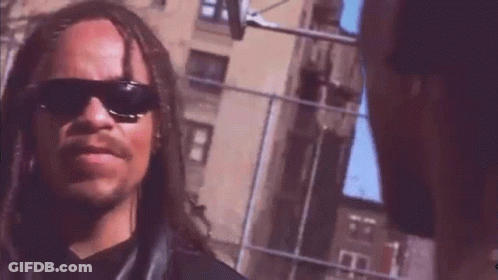 Man With Long Hair And Mustache In Sunglasses Next To Another Man GIF