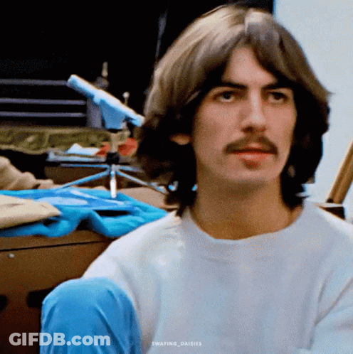 Man With Long Hair And Mustache In White T-Shirt GIF