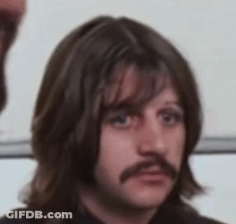 Man With Long Hair And Mustache Making Face GIF