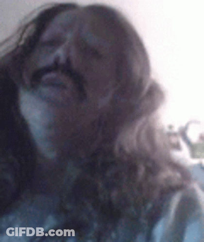 Man With Long Hair And Mustache Making Funny Face GIF