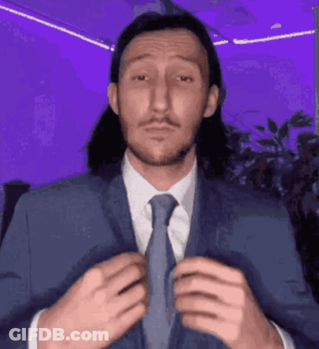 Man With Long Hair And Mustache Wearing Suit And Tie GIF