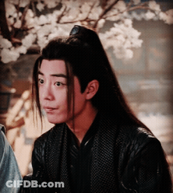 Man With Long Hair And Ponytail In Black Jacket GIF