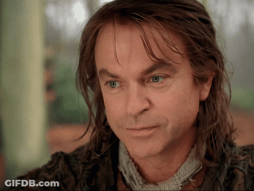 Man With Long Hair And Scarf Looking At Camera GIF