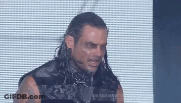 Man With Long Hair And Tattoos Eyes Closed In Front Of Screen GIF
