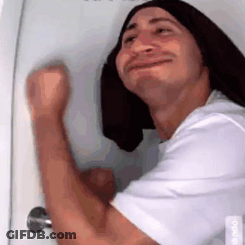 Man With Long Hair And Towel On Head Standing In Front Of Door GIF
