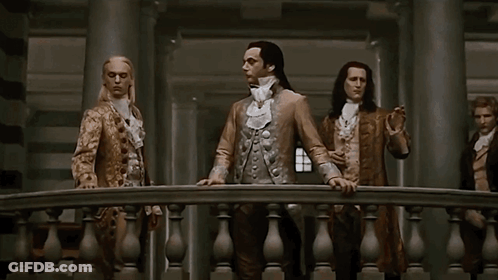 Man With Long Hair Between Two Men GIF
