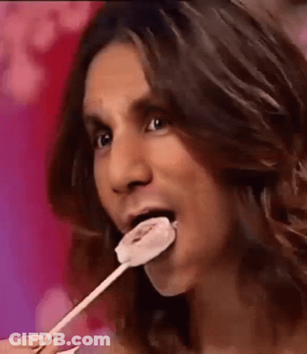 Man With Long Hair Eating Lollipop GIF