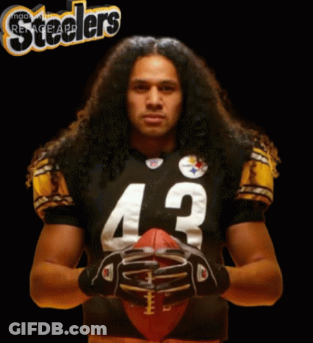 Man With Long Hair Holding Football GIF