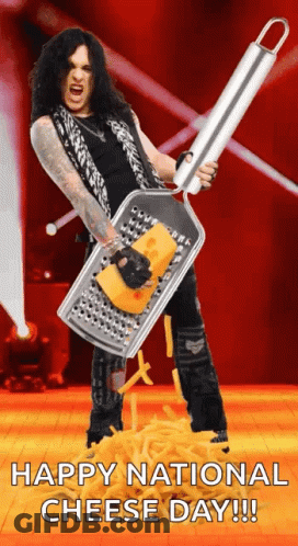 Man With Long Hair Holding Grater With Cheese GIF
