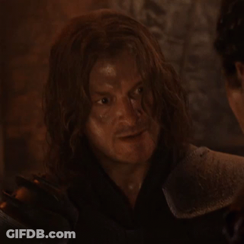 Man With Long Hair In Armor Looking At Another Man GIF