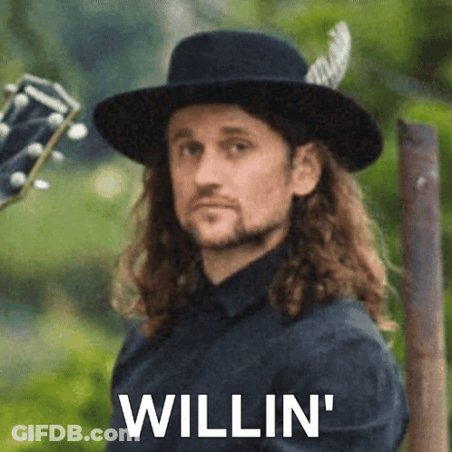 Man With Long Hair In Black Hat Holding Guitar 'Willin GIF