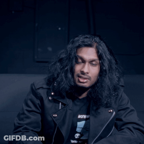 Man With Long Hair In Black Shirt Saying Vote GIF