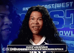Man With Long Hair In Front Of East/West Bowl Sign GIF