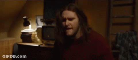 Man With Long Hair In Front Of Lamp And TV GIF