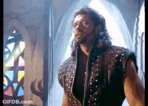 Man With Long Hair In Front Of Stained Glass Window GIF