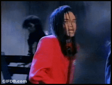 Man With Long Hair In Red Jacket Singing GIF