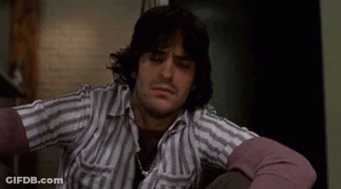 Man With Long Hair In Striped Shirt And Purple Sweater GIF