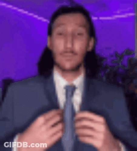 Man With Long Hair In Suit And Tie GIF