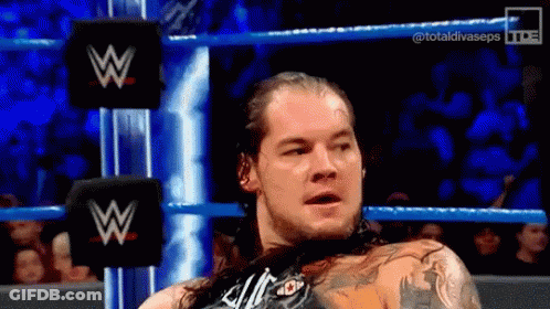 Man With Long Hair In Wrestling Ring With W Logo GIF