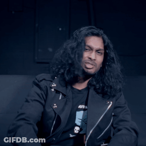 Man With Long Hair Looking At Camera GIF