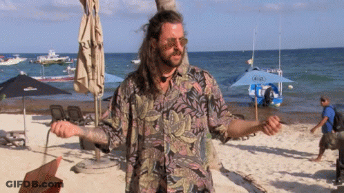 Man With Long Hair On Beach With Boat GIF