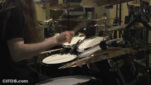Man With Long Hair Playing Drum Set Saying Evans GIF