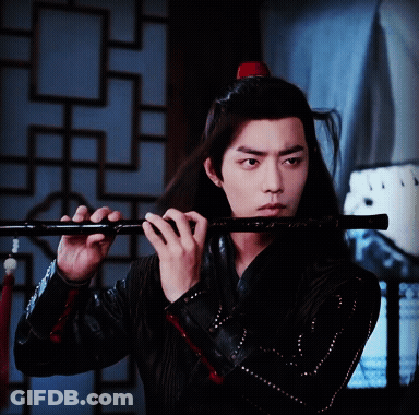 Man With Long Hair Playing Flute GIF