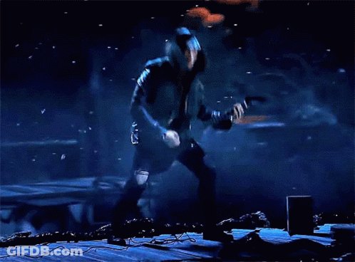 Man With Long Hair Playing Guitar In Dark GIF