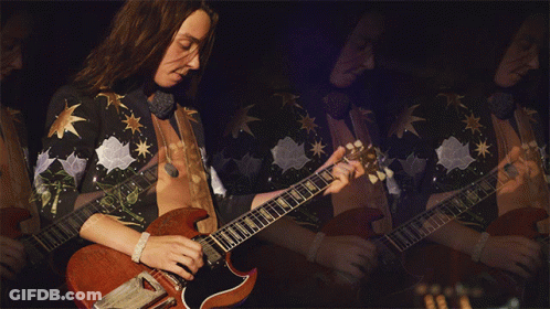 Man With Long Hair Playing Guitar In Mirror GIF