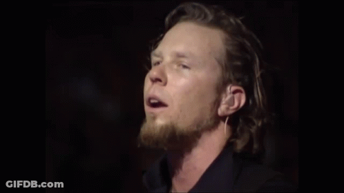 Man With Long Hair Singing Into Mic GIF