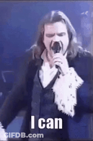 Man With Long Hair Singing Into Microphone GIF