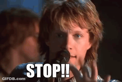 Man With Long Hair Singing Into Microphone While Guitarist Plays On Stage GIF