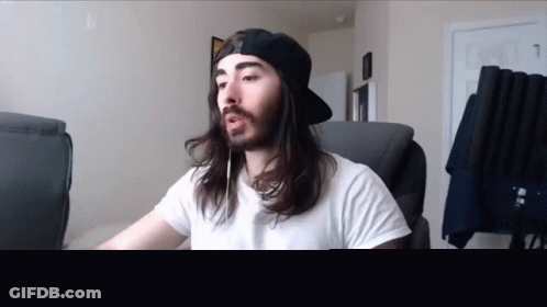 Man With Long Hair Sitting At Microphone GIF